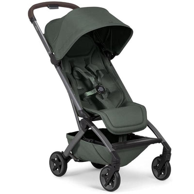 Lightweight compact stroller in forest green with a reclining seat, adjustable canopy, and four swivel wheels.