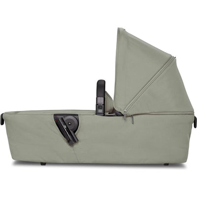 Sage green Joolz Aer+ carrycot with a removable canopy and side handle for easy carrying.