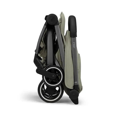Lightweight Joolz Aer+ stroller in sage green, folded compactly with visible wheels and handle.