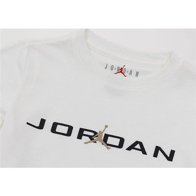White short-sleeve t-shirt featuring the Jordan logo in black and gold with a red Jumpman emblem above.