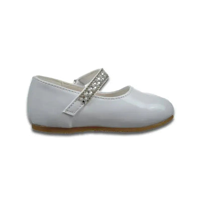 White baby girl christening shoe with a rounded toe and a decorative strap featuring rhinestones.