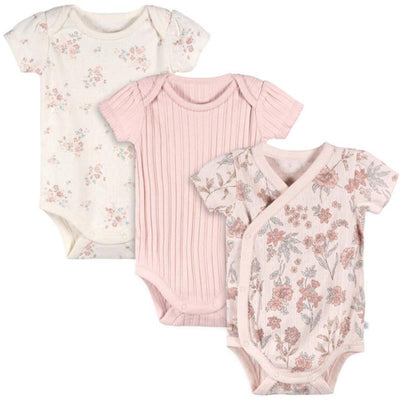 Three baby girl kimono bodysuits in pink tones: one with floral print, one ribbed, and one with a floral design on a light background.
