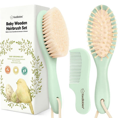 Baby wooden hairbrush and comb set in sage color, featuring soft bristles and a small wooden comb, packaged in a decorative box.