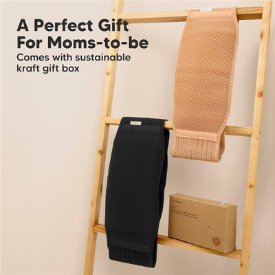 Maternity belly bands in black and peach displayed on a wooden ladder, with a kraft gift box below.