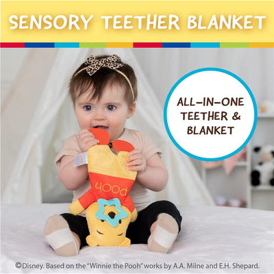 A baby with a leopard-print headband holds a colorful Winnie the Pooh sensory blanky, featuring crinkle fabric and a teether.