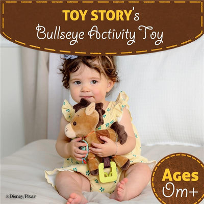 Child holding a plush Bullseye toy from Toy Story, featuring vibrant colors and a plastic clip, suitable for ages 0+.
