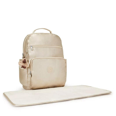Metallic gold Kipling So Baby Diaper Bag with a front pocket, zipper, and a plush monkey keychain, accompanied by a changing mat.