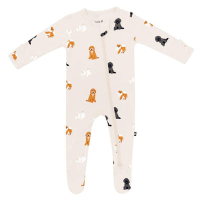 Baby neutral zippered footie featuring a fluffy dog design, showcasing various dog illustrations in orange, black, and white on a cream background.