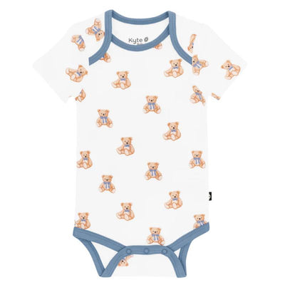 Short-sleeved white bodysuit featuring a playful teddy bear print, with a blue trim around the neckline and legs.