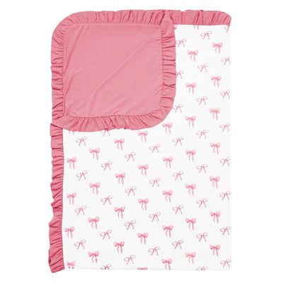 Ruffled toddler blanket featuring a pink bow pattern on a white background, with a solid pink ruffle edge.