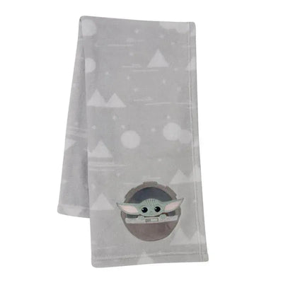 Appliqued baby blanket featuring a cartoon Baby Yoda with large ears, on a soft gray background with geometric patterns.