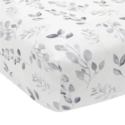 Fitted crib sheet from Lambs & Ivy featuring a painted forest design with gray leaves on a white background.
