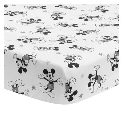 Fitted crib sheet featuring a playful black and white Mickey Mouse pattern with scattered stars.