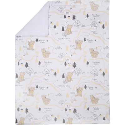 Lambs & Ivy Winnie the Pooh baby blanket featuring playful illustrations of Pooh and friends against a neutral background.