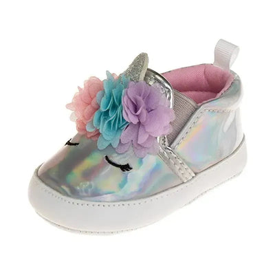 Metallic silver crib shoe for girls featuring a unicorn design, colorful flower decorations, and a soft pink interior.