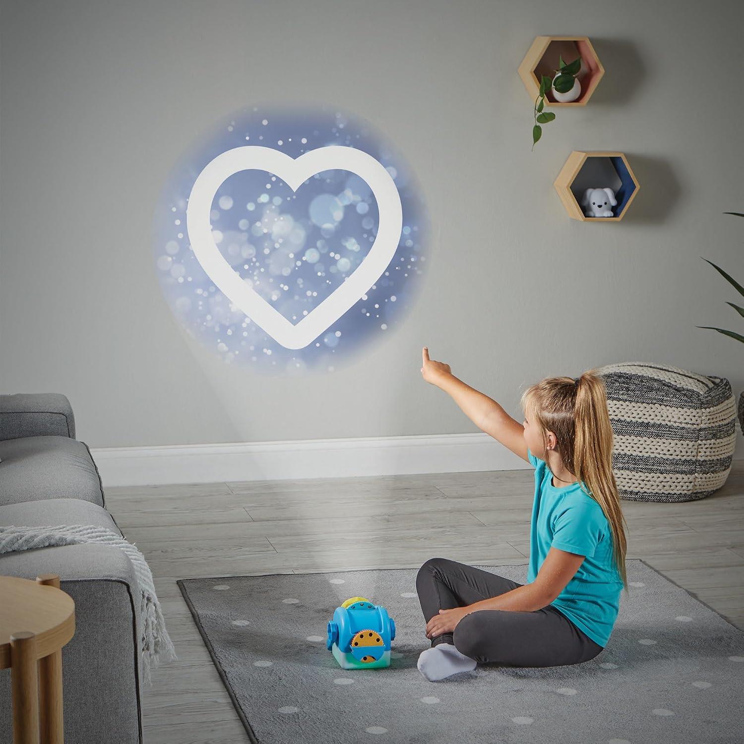 Child points at a heart-shaped light projection on the wall from the Learning Resources Calming Moments Projector.