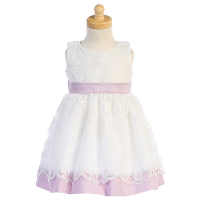 Lito Baby Girl Dress in lilac, featuring embroidered mesh with poly silk trims and a floral design on the bodice.