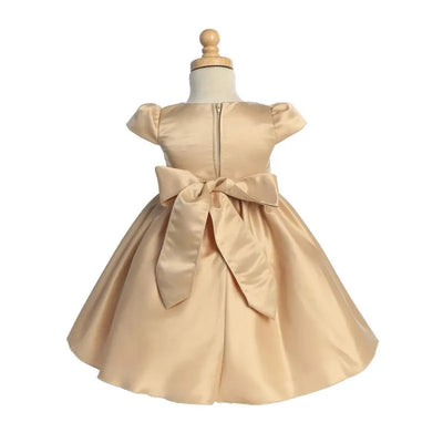 Baby girl satin dress in gold, featuring puff sleeves, a decorative bow at the back, and a zip closure.