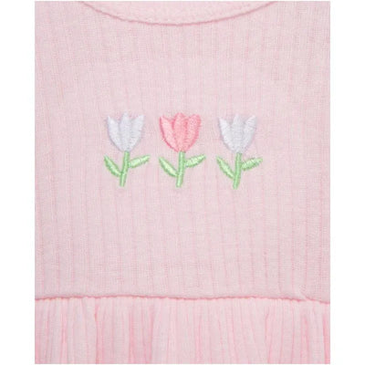 Pink baby dress featuring embroidered tulip flowers in white, pink, and green, with a gathered ruffle hem.