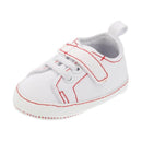 Little Me Baby Boy Sneaker in white with red stitching and a Velcro strap for easy wear.