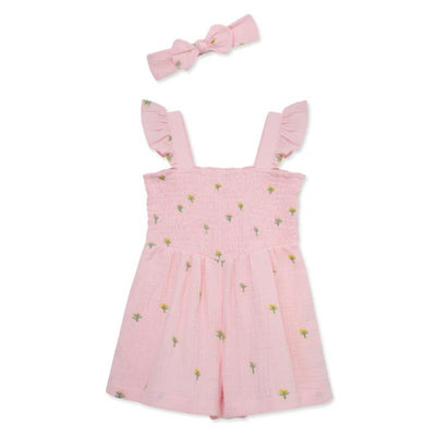 Pink floral schiffli woven romper for baby girls, featuring ruffled straps and accompanied by a matching headband.