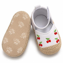 Espadrille-style baby girl sandals by Little Me, featuring white fabric with embroidered cherries and a textured sole.