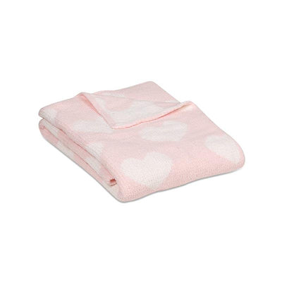 Chenille baby blanket in pink with white heart patterns, folded neatly for display.