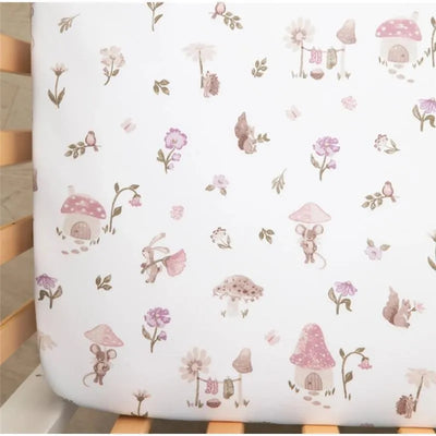 Cotton jersey fitted sheet with whimsical mushroom and animal illustrations in soft pink and earth tones.