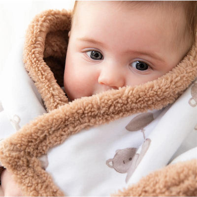 Baby wrapped in a cozy Living Textiles Jersey Sherpa Blanket featuring a bear design.