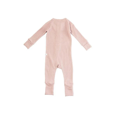 Waffle sleeper in blush pink, featuring long sleeves and ribbed texture, suitable for infants.
