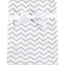 Coral fleece baby blanket in gray chevron pattern, tied with a white ribbon for secure display.