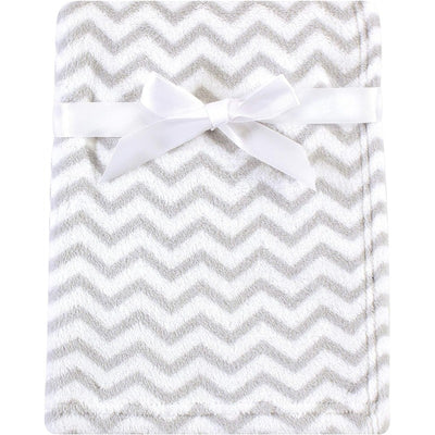 Coral fleece baby blanket in gray chevron pattern, tied with a white ribbon for secure display.