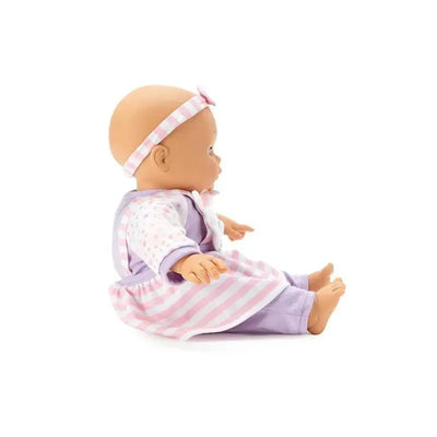Baby doll wearing a purple and pink outfit with a striped dress and a headband, sitting sideways.