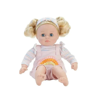 Doll with blonde curly hair in pink overalls featuring a rainbow design, wearing a striped long-sleeve shirt.