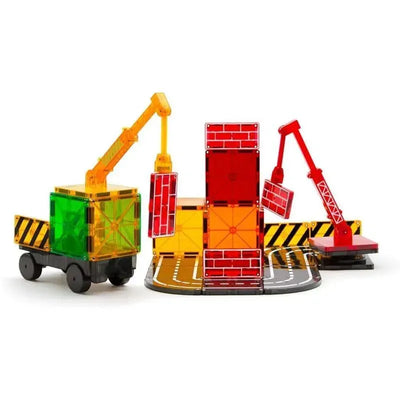 Brightly colored magnetic construction set featuring cranes and building blocks in a playful scene.
