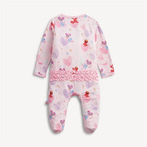 Ruffle-footed onesie in pink featuring cartoon bears and Elmo, with a ruffled waistband and colorful heart patterns.