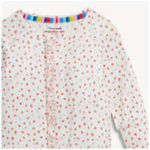 Ruffly convertible coverall by Magnetic Me, featuring a white background with small pink and red apple blossom patterns.