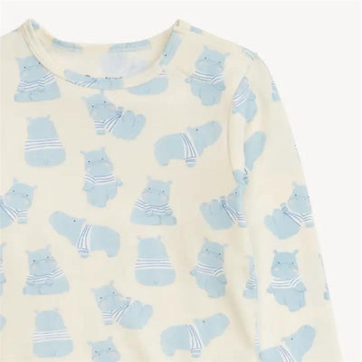 Long sleeve baby pajamas in soft modal fabric, featuring a playful hippo print in blue against a cream background.