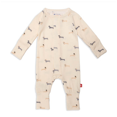 Beige coverall with long sleeves, featuring playful dachshund patterns in various colors, designed for infants.