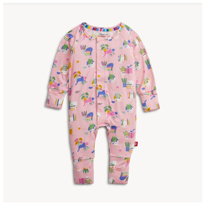 Modal convertible coverall in pink with playful patterns of books, plants, and animals, featuring a front snap closure.