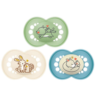 Three colorful baby pacifiers, featuring playful animal designs, packaged in a set for day and night use.