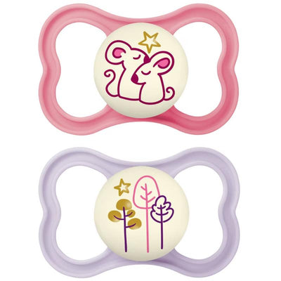 Two Mam air night baby pacifiers for sensitive skin, featuring a pink design with mice and a purple design with trees, glow in the dark.