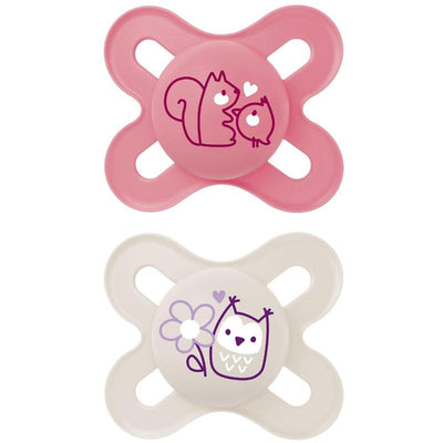 Two Mam baby pacifiers for girls, one pink featuring a squirrel and bird graphic, and one white with an owl and flower design. Suitable for 0-3 months.