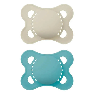 Two matte unisex pacifiers in beige and blue, designed for children aged 16 months and older, showcasing a rounded shape and ventilation holes.