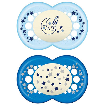 Two Mam original night baby pacifiers in blue and light blue, featuring glow-in-the-dark designs with stars and a rocket motif.