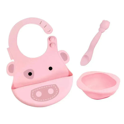 Baby feeding set by Marcus & Marcus includes a pink bib shaped like a cow, a matching bowl, and a spoon.