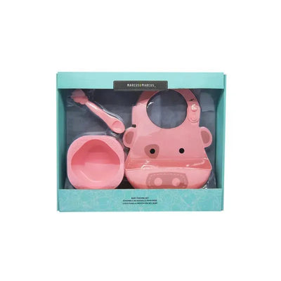 Baby Feeding Set by Marcus & Marcus, featuring a pink bib with a pig design, a spoon, and a bowl, in a clear package.