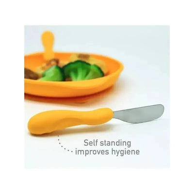 Easy Grip Cutlery Set in yellow, featuring a knife with a self-standing design for improved hygiene, next to a colorful plate of food.