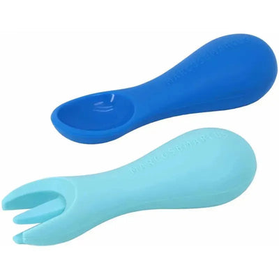 Silicone palm grasp spoon and fork set in blue and light blue, designed for toddlers by Marcus & Marcus.