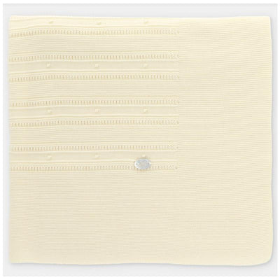 Knit baby blanket in creamy white with textured patterns and a silver label, designed for warmth and comfort.